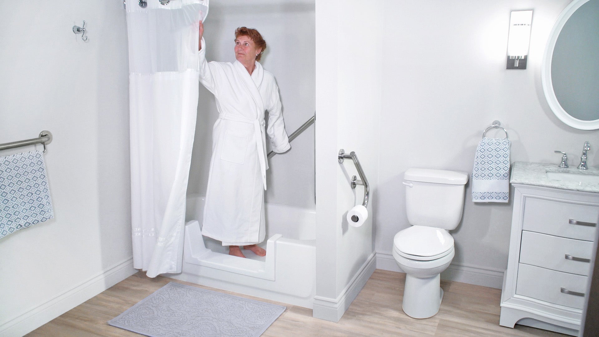 An older lady closing the shower curtain after stepping into her Quick Tub converted bathtub